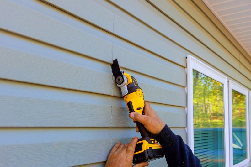 Technician Inspecting Vinyl Siding